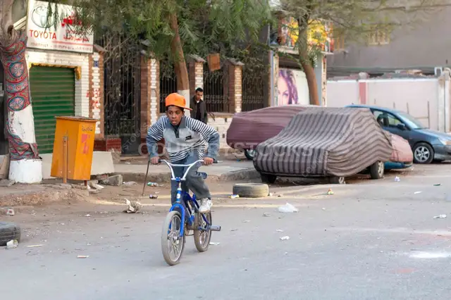 Egyptian Boy Riding Bicycle on Cairo Street