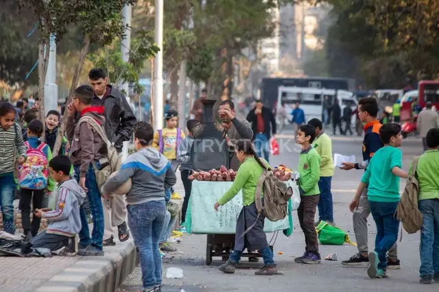 Sweet Potato Cart Vendor Among Schoolchildren, Sudan Street Cairo