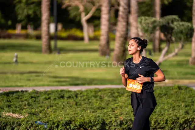 Female Runner Participating in a Marathon Race