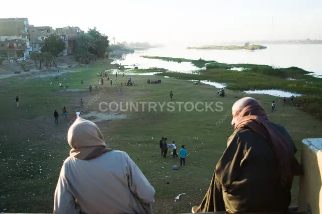 Spectators Watch a Community Football Match Along the Nile