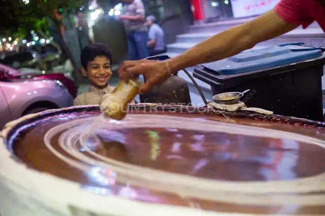 Traditional Kanafany (traditional konafa maker) Preparing Baladi Konafa in Al-Fustat, Egypt