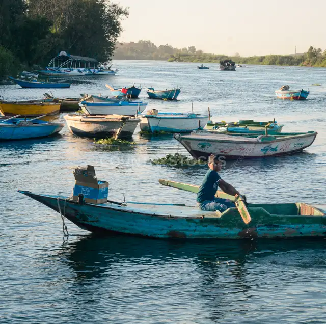 Fisherman Rowing Wooden Boat, Al-Qanater Al-Khayriyya