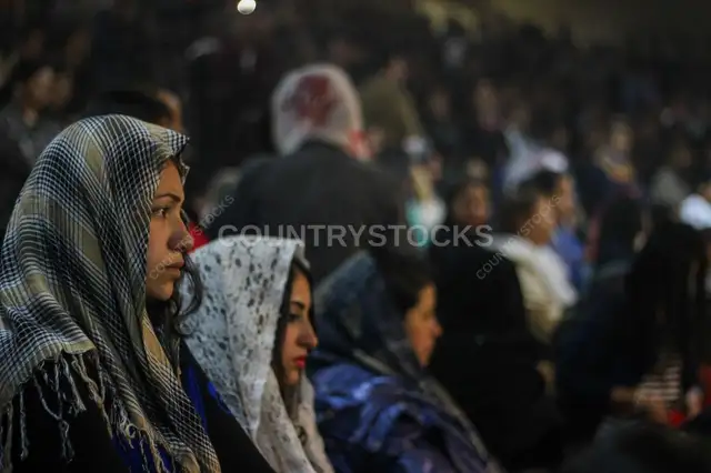A Young Woman in Prayer on a Feast Day in Church