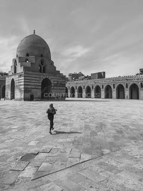 Person Walking in Ibn Tulun Mosque Courtyard, Cairo