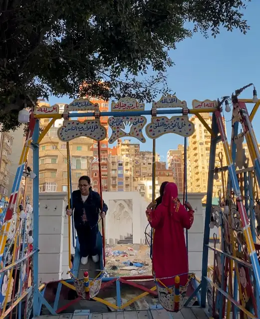 Girls Playing on Traditional “Moulid” Swings in Egypt