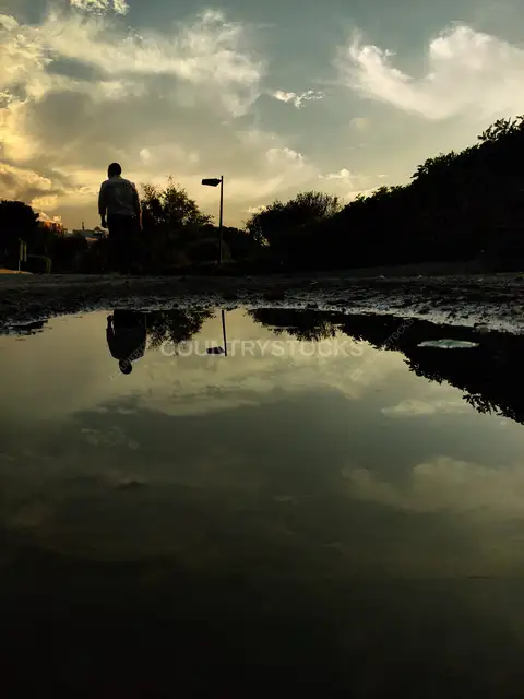 Person Silhouette Reflected in Puddle, Al-Azhar Park Cairo