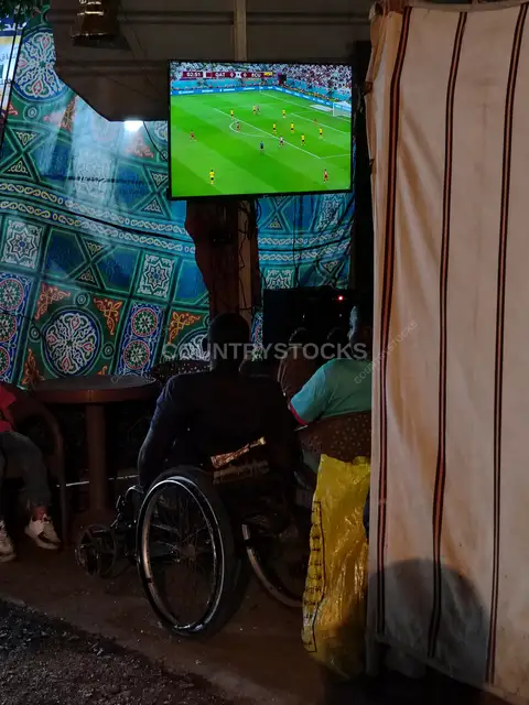 Wheelchair Fan & Foreign Residents in Egypt Watching World Cup Match at Local Café