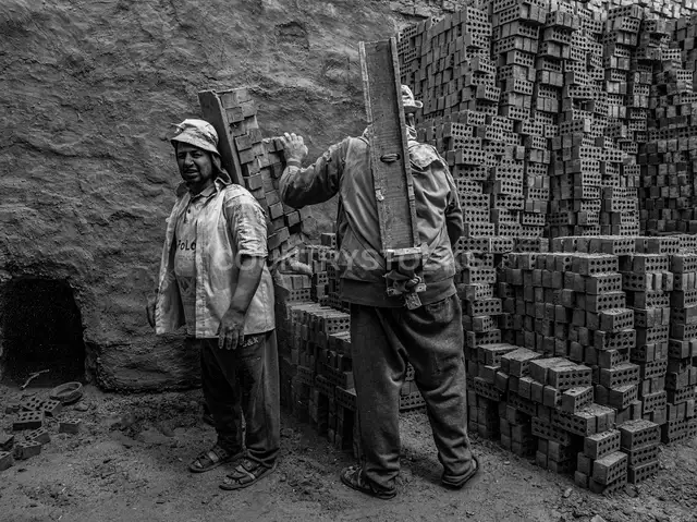 Workers Carrying Bricks at Al-Qanater Al-Khayreya Site