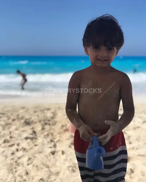 Little Child Covered in Sand on the Beach at Egypt's North Coast