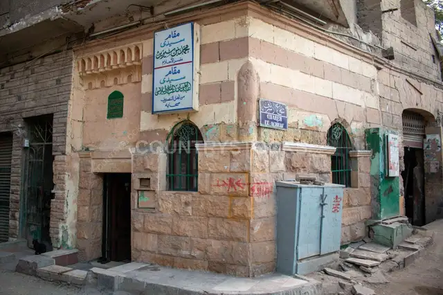 Corner Shrine Building on Al-Ashraf Street with Historic Signage in Cairo 2017