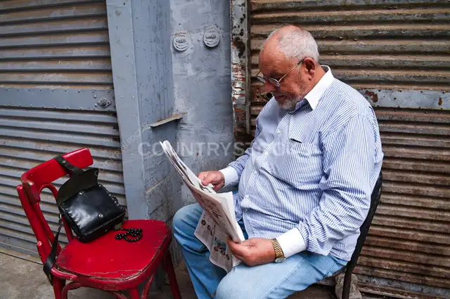 Man Reading Newspaper, Al-Gamaliya Street, Cairo