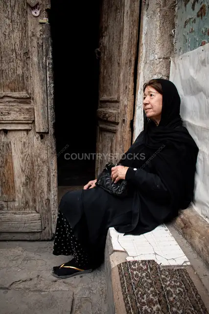 Egyptian Woman Sitting Outside Historic Door, Cairo