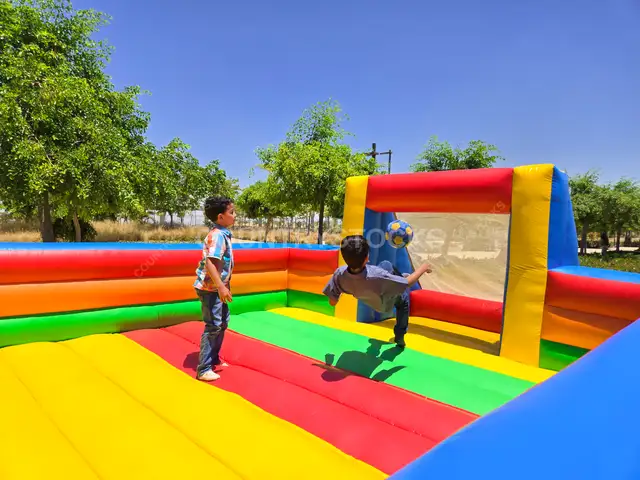 Football Fun Inside an Inflatable Playground