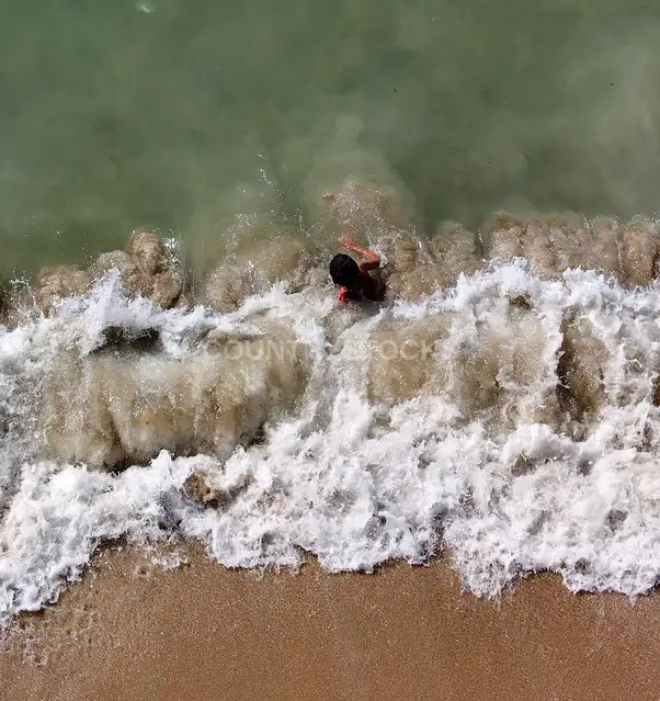 Top View of a Child Facing the Waves in Alexandria