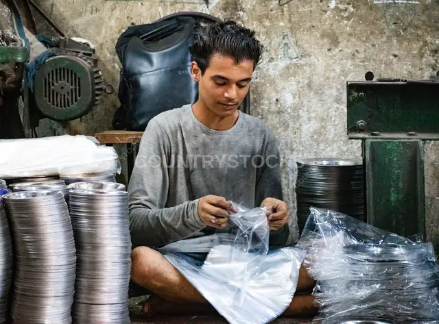 Young Worker Packaging Metal Dishes, Al-Gamaliya Cairo