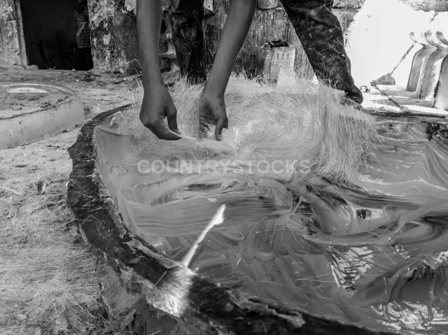 Worker Placing Fiberglass Raw Material Into Mold