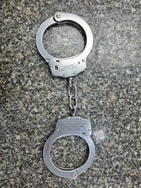 Metal Police Handcuffs on Granite Surface, Cairo