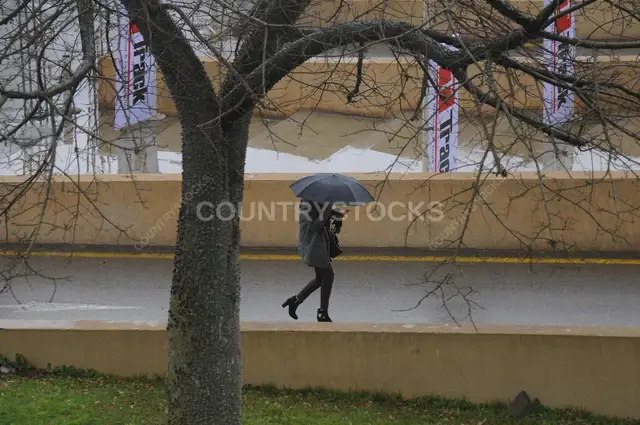 Woman Walking with Umbrella on Cairo Street