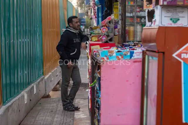 Man Standing by Neighborhood Kiosk, Cairo Street