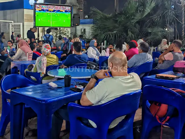 Egyptians Watching Football Match at Outdoor Café Night