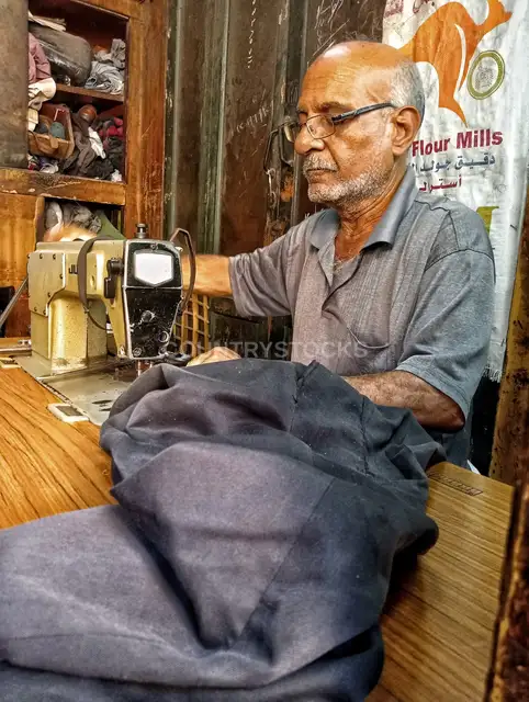 Traditional Egyptian Tailor Working in Al-Muizz Street Cairo