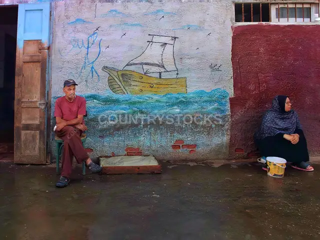 Man and Woman Seated by Ship Mural, Ezbet El Borg Fish Market