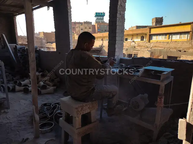Egyptian Drum Maker Stretching Tabla Skin in a Traditional Workshop