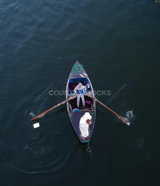 Two Fishermen Rowing Small Boat on Nile River Qena