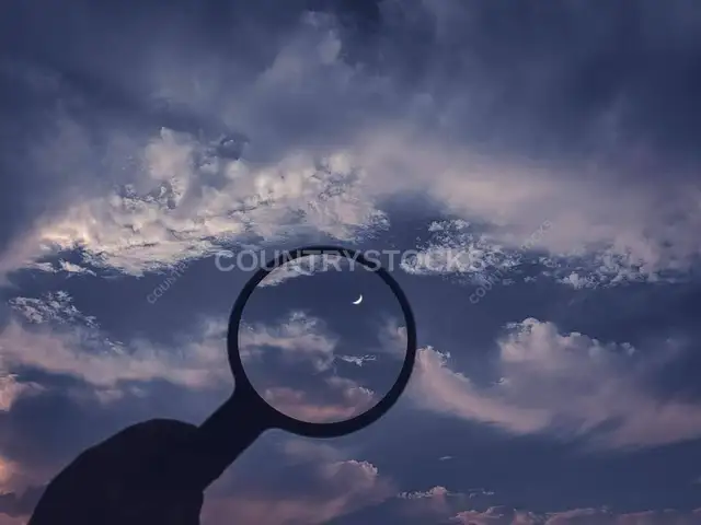 Magnifying Glass Aimed at Crescent Moon, Cloudy Sky