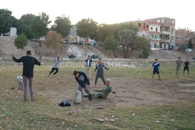 Local Football Match on a Dirt Field in Qena, Egypt