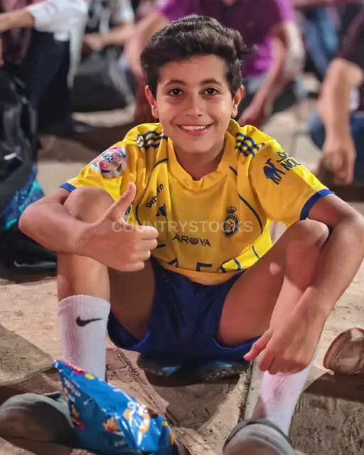 Happy Egyptian Boy Thumbs Up in Al-Nassr Jersey