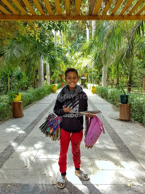 Child Street Vendor Selling Handicrafts, Qena Garden