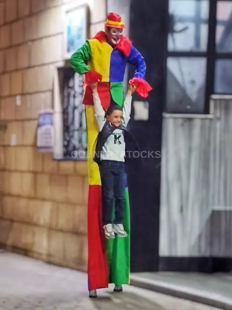Stilt Clown Holds Smiling Child, National Circus Giza