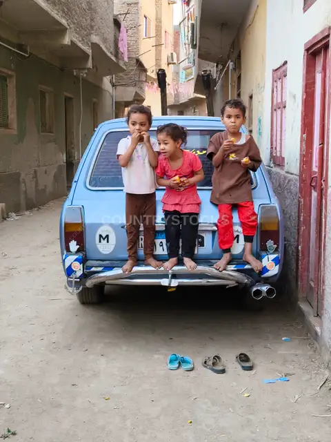 Three Children on Old Car, Qena Alley, Upper Egypt
