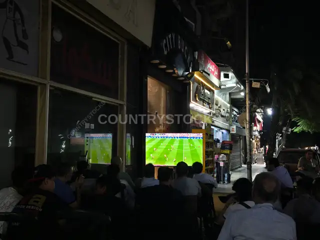 Crowd Watching Football Match at Cairo Street Café Night