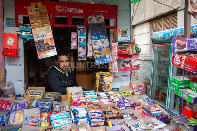 Kiosk Owner Among Snacks and Products, Cairo