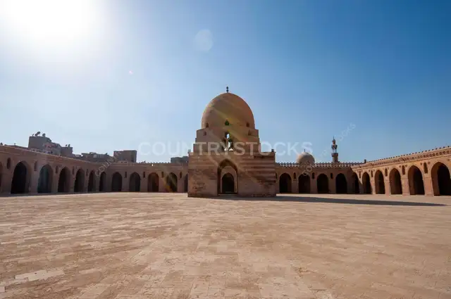 Architectural view of the central dome and spiral minaret of the historic Ahmad Ibn Tulun Mosque in Old Cairo, Egypt