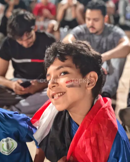 Young Egyptian Fan with Flag Face Paint at Match
