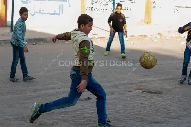 Boys Playing Street Football, Sudan Street Cairo 2017
