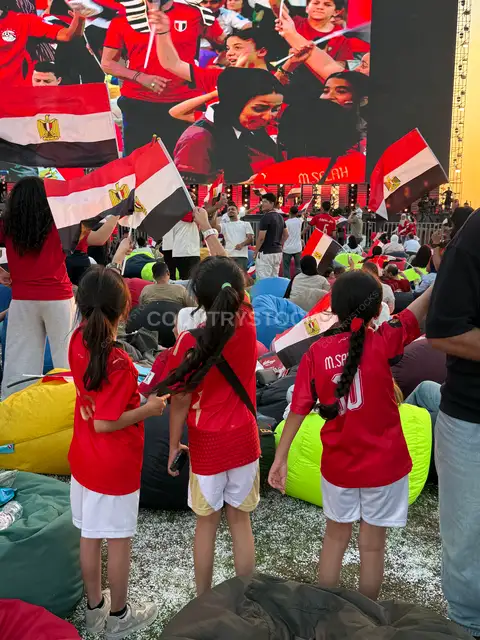 Egyptian Children Cheering at Football Fan Zone Screen