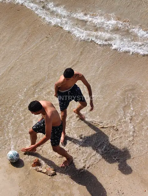 Two Men Playing Football on Alexandria Beach