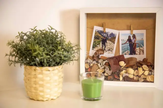 Cozy Home Decor with Framed Travel Memories & Green Candle – Modern Lifestyle Photography
