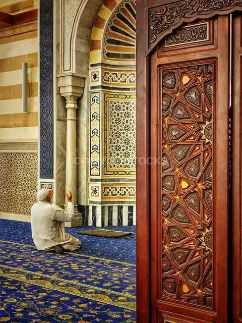 رجل يصلي نحو القبلة في مسجد السيدة زينب بالقاهرة