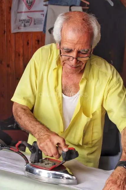 Elderly Craftsman Ironing Clothes, Traditional Workshop Alexandria