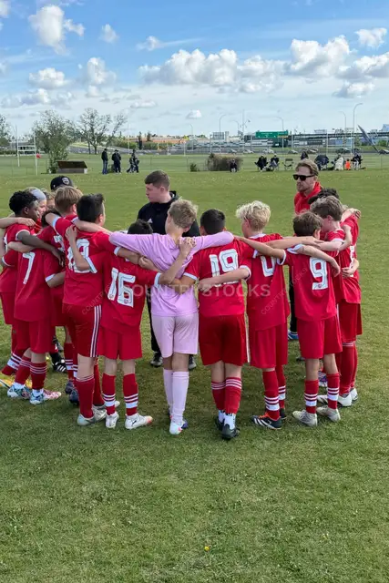 Youth Soccer Team Huddle Before Match Outdoors