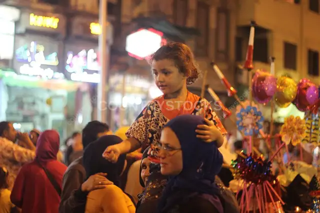Women Carrying Children on Their Shoulders During Festive Mawlid Celebration – Cairo, Egypt 2