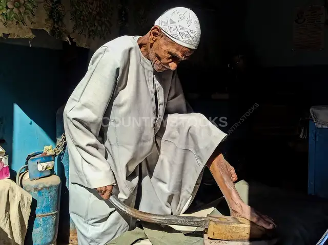 Elderly Man Using Foot Iron, Esna Luxor