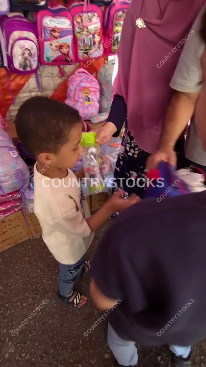 Child Choosing School Supplies at Cairo Street Vendor