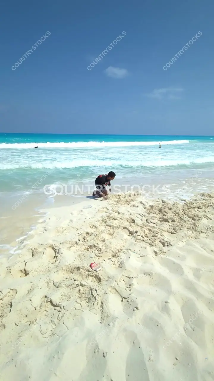 Child Building Sandcastle at El Alamein Beach