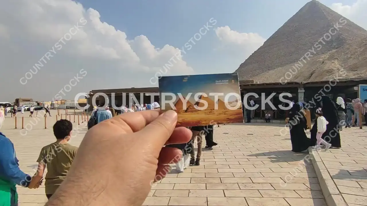 Hand Holding Giza Pyramids Entry Ticket, Great Pyramid Background